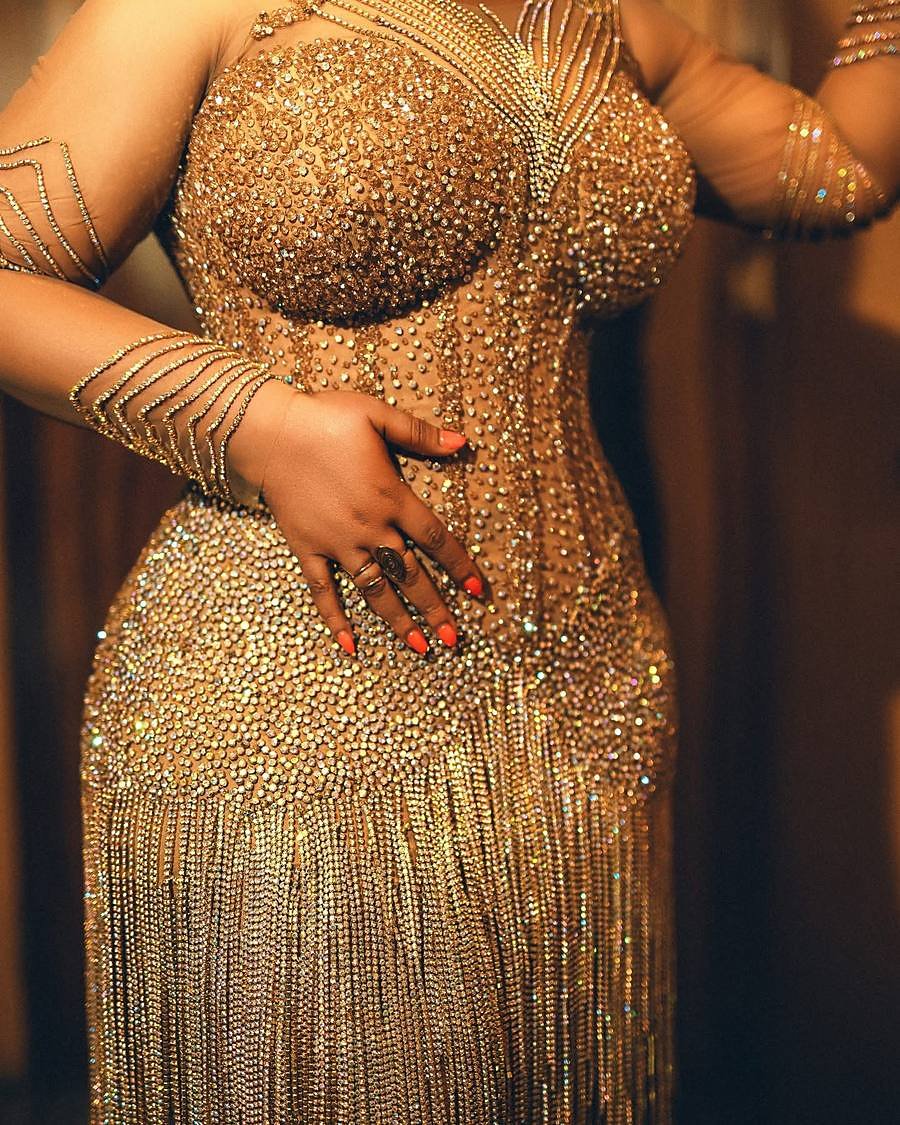 Hand-applied gold crystals, chain fringe, and rings in extreme close-up showing over 600 hours of atelier craft