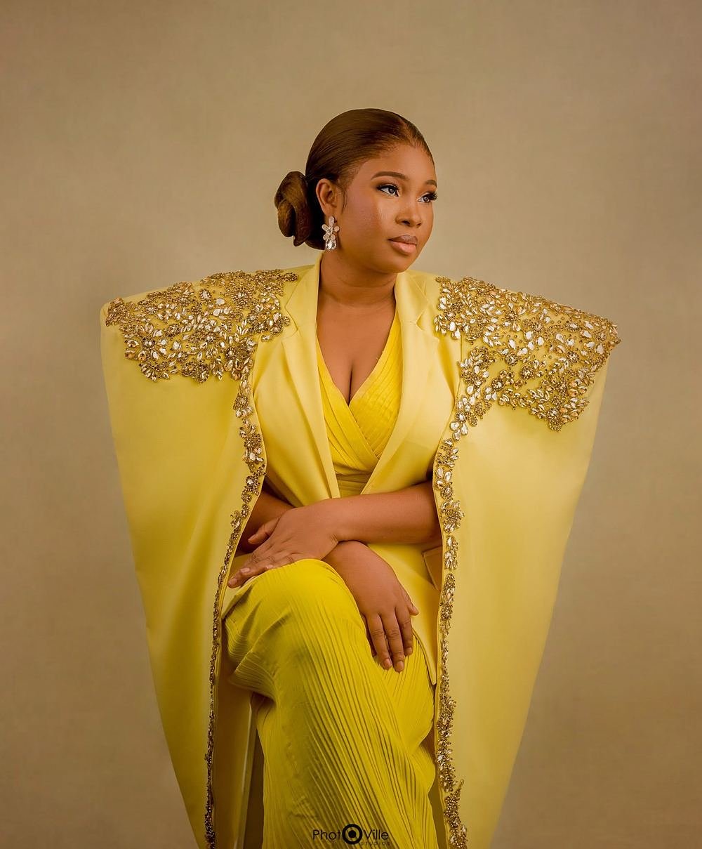 Harriet Edide in the Finiee yellow cape suit with gold beaded shoulders