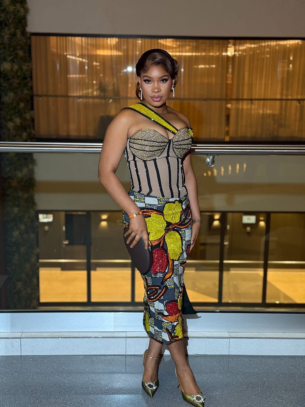 The Collision, a printed ankara occasion dress photographed at night