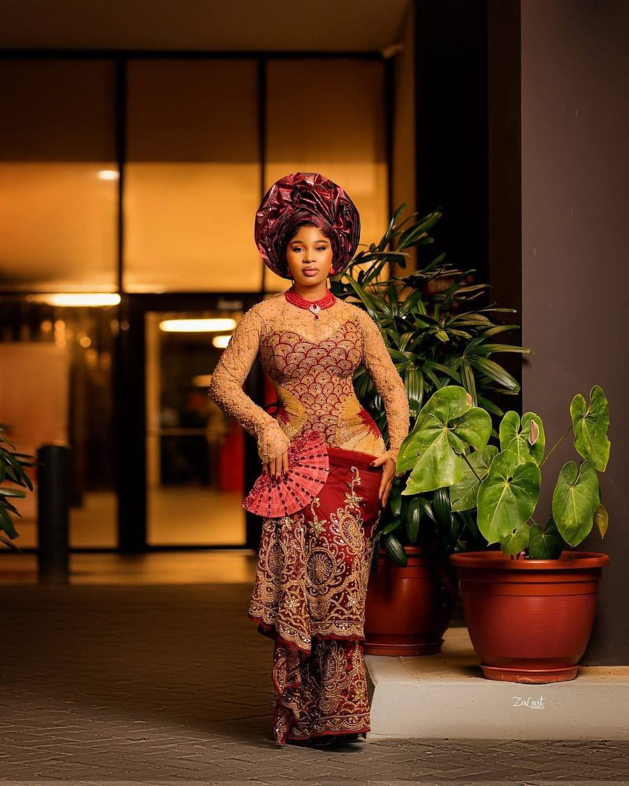 Red and gold traditional ceremony ensemble at night