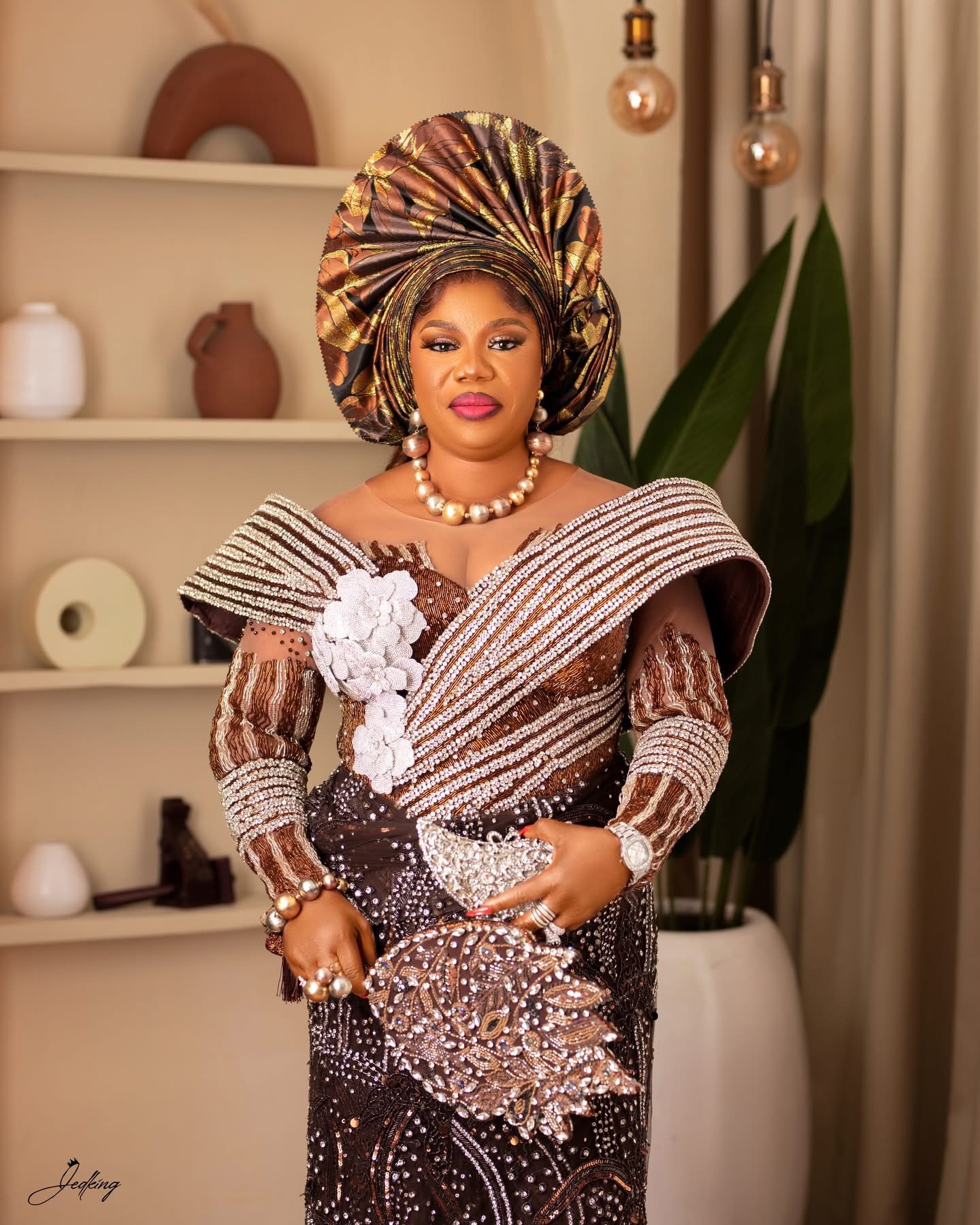 Brown and gold beaded traditional ensemble with gele