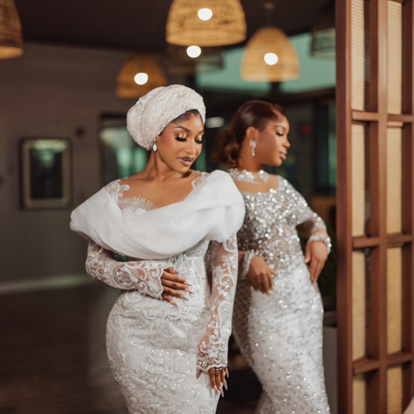 Two women in white and silver beaded gowns