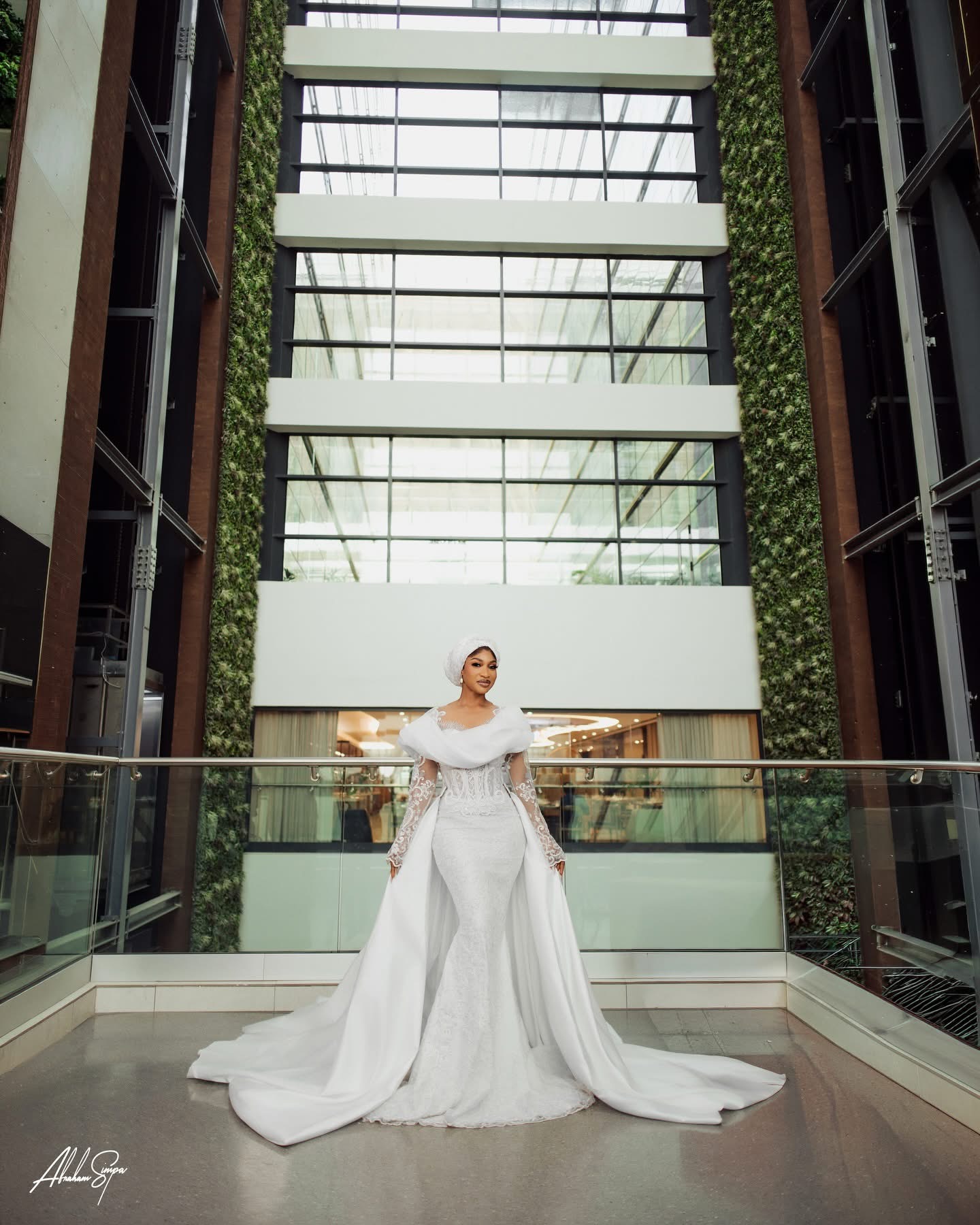Bride in white gown with architectural backdrop