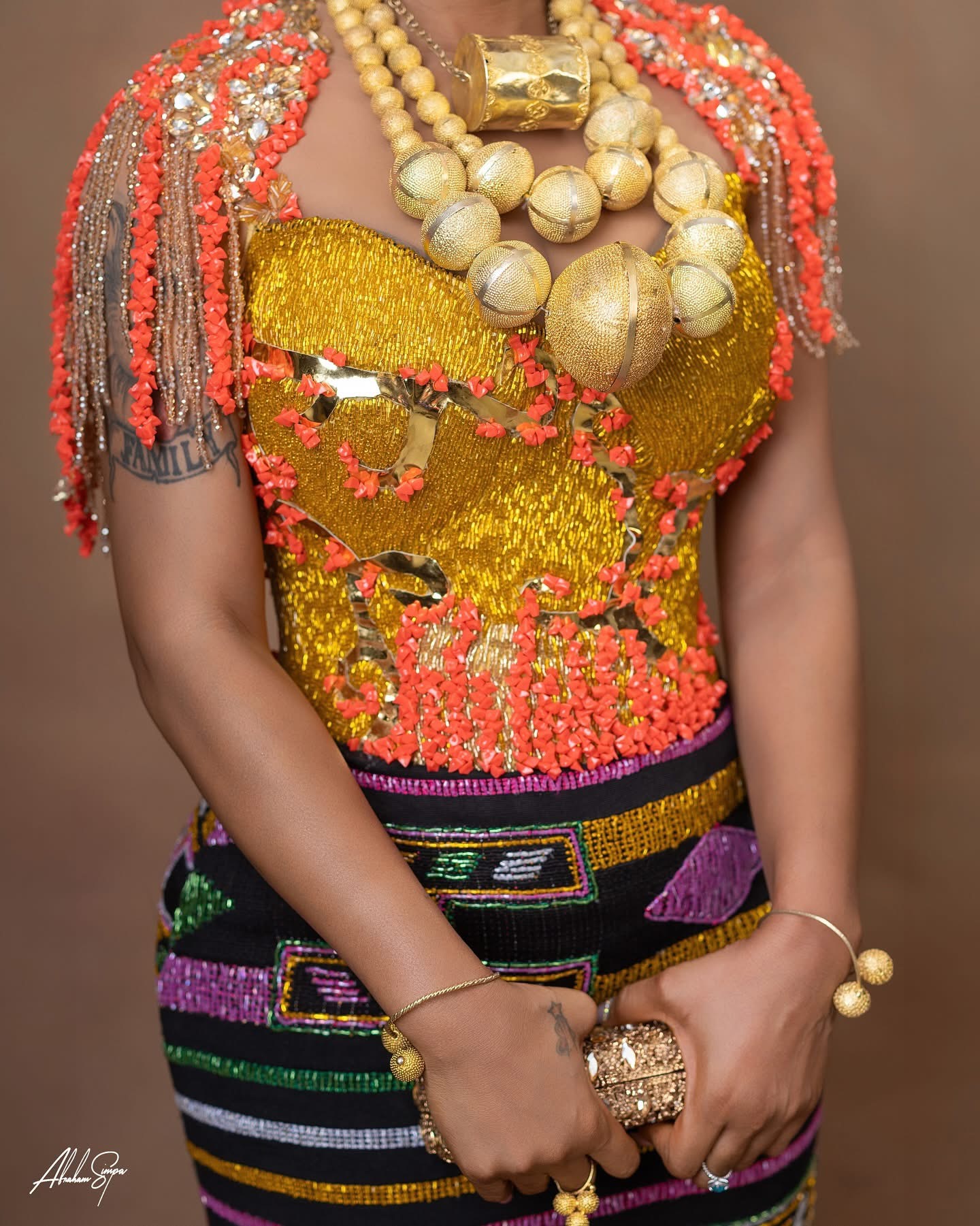 Traditional gold and coral beadwork bodice detail with fringe