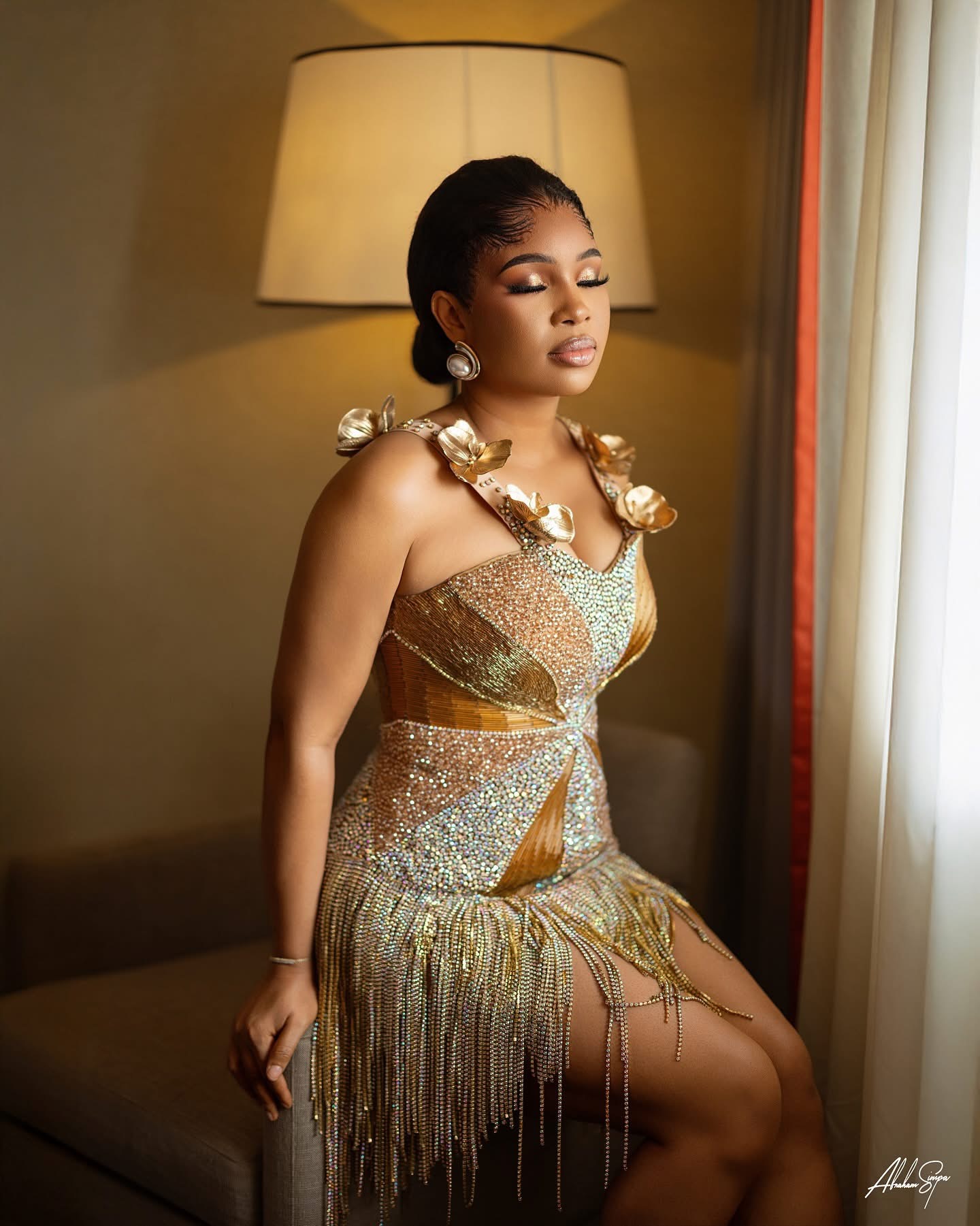 Burnt orange aso-oke dress with sculptural pleated train