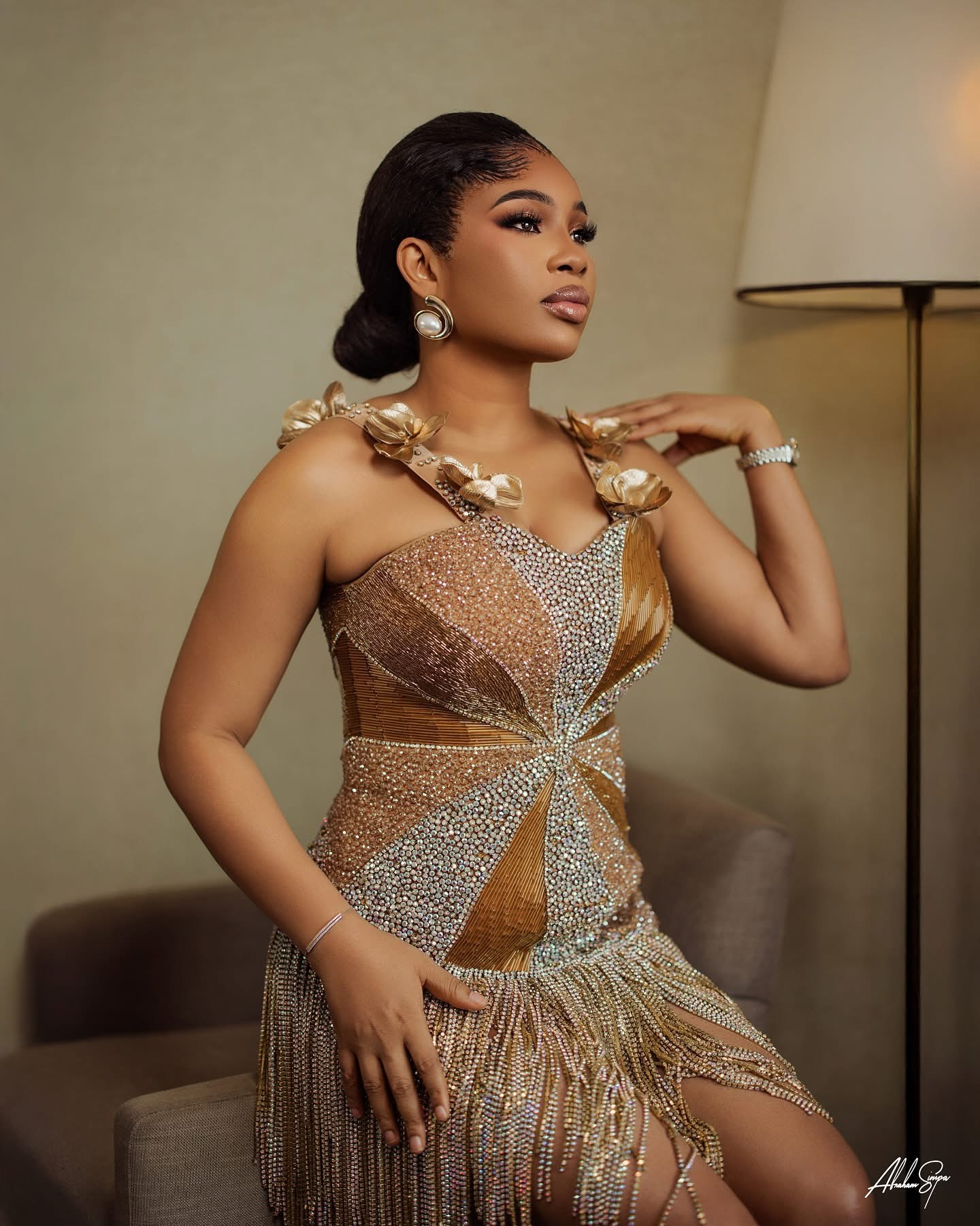 Gold crystal fringe gown with sculptural flora detail, evening editorial