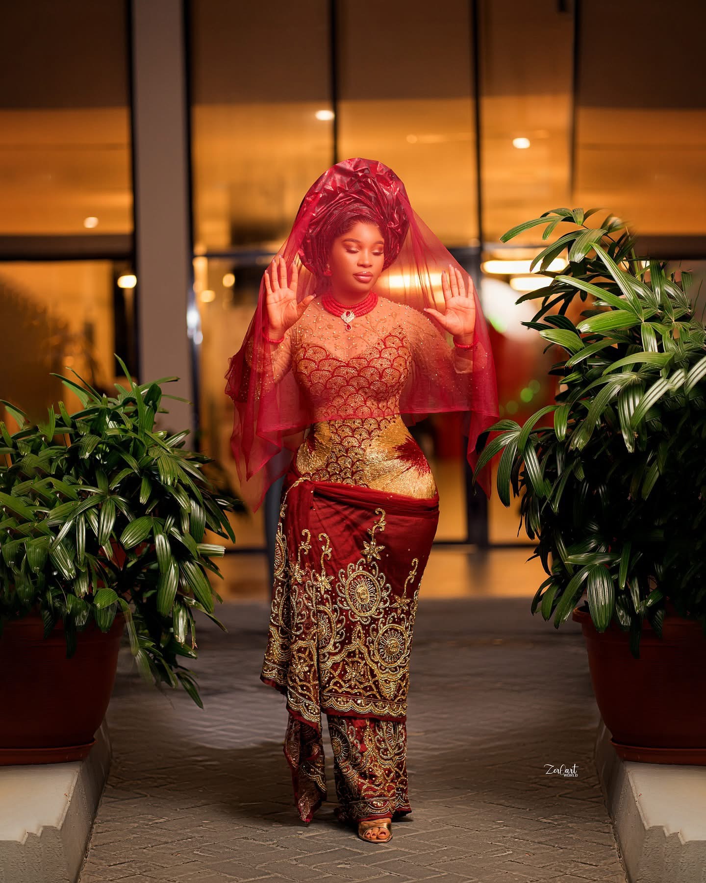 Red traditional ceremony ensemble with veil